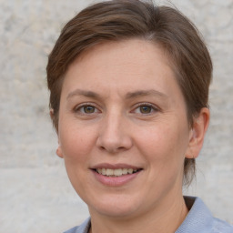 Joyful white adult female with short  brown hair and grey eyes