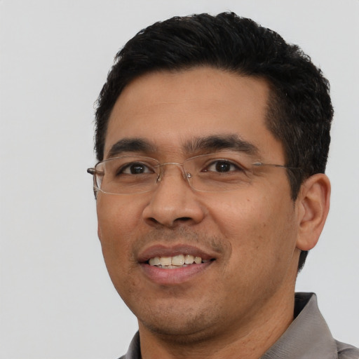 Joyful asian young-adult male with short  black hair and brown eyes