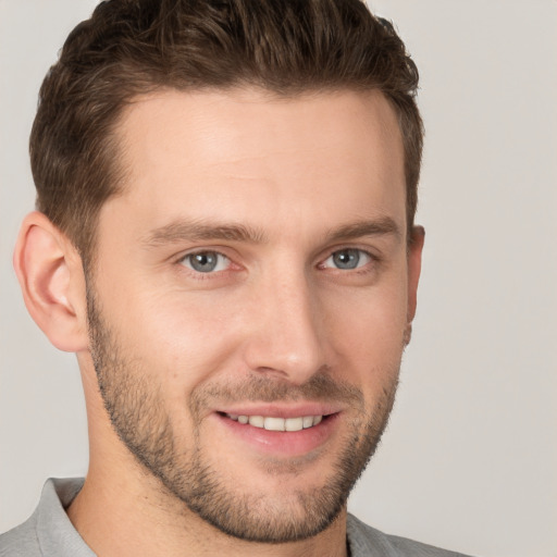 Joyful white young-adult male with short  brown hair and brown eyes