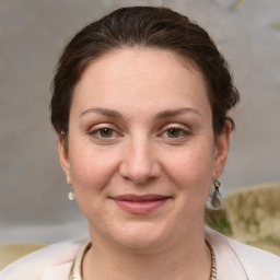 Joyful white young-adult female with medium  brown hair and grey eyes