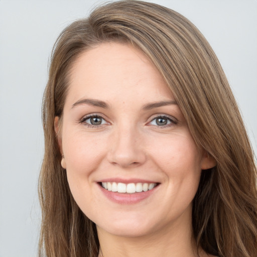 Joyful white young-adult female with long  brown hair and grey eyes