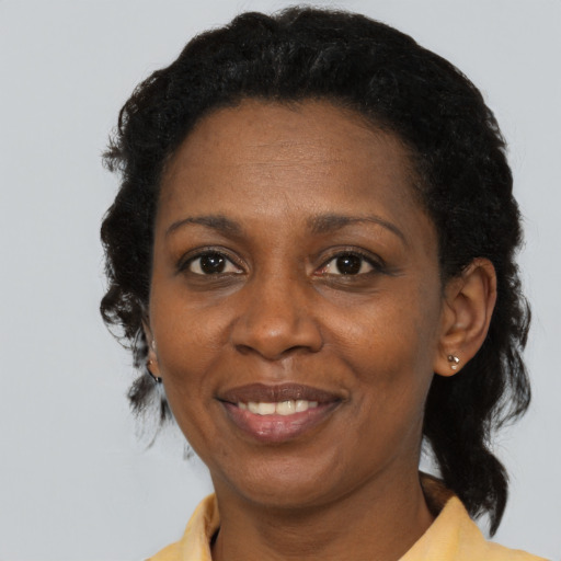 Joyful black adult female with medium  black hair and brown eyes