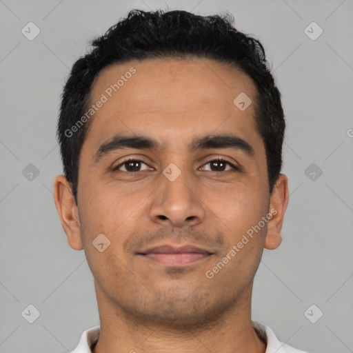 Joyful latino young-adult male with short  black hair and brown eyes