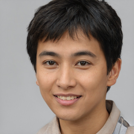 Joyful asian young-adult male with short  black hair and brown eyes
