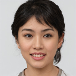 Joyful asian young-adult female with medium  brown hair and brown eyes