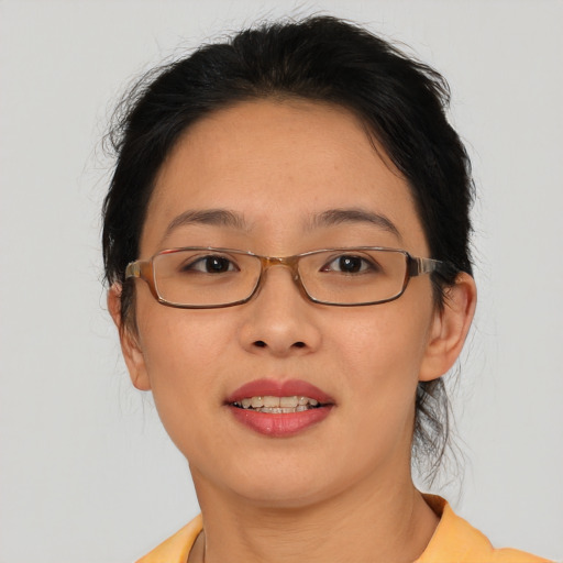 Joyful asian adult female with medium  brown hair and brown eyes