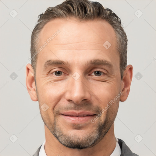 Joyful white adult male with short  brown hair and brown eyes