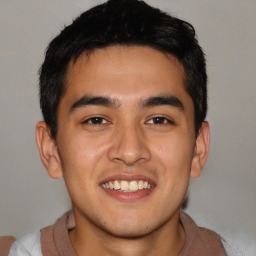 Joyful latino young-adult male with short  brown hair and brown eyes