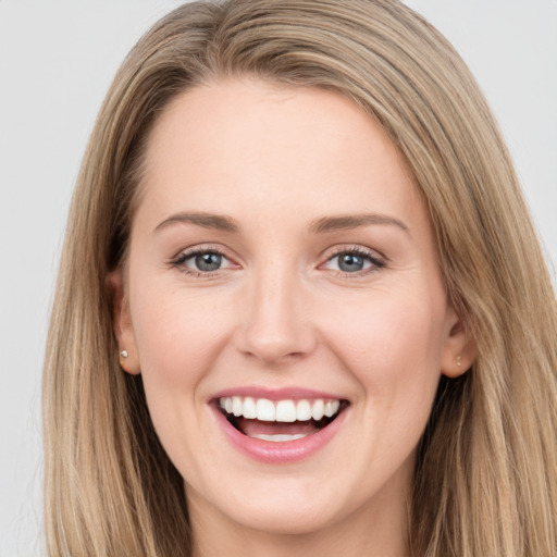 Joyful white young-adult female with long  brown hair and grey eyes