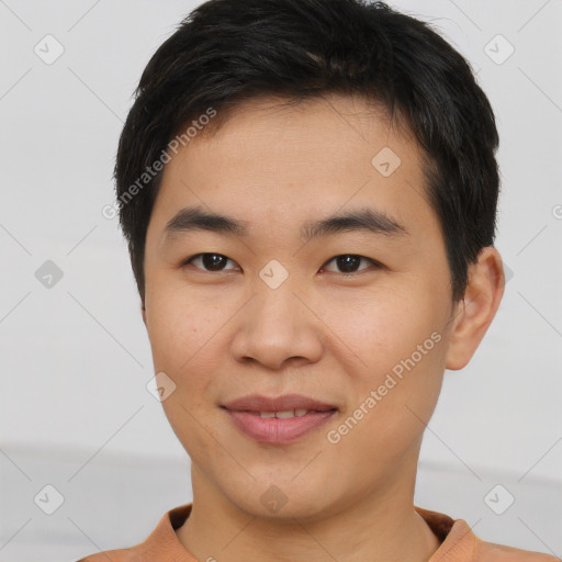 Joyful asian young-adult male with short  brown hair and brown eyes