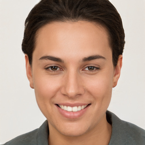 Joyful white young-adult female with short  brown hair and brown eyes