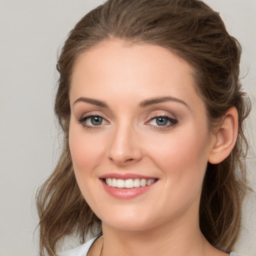 Joyful white young-adult female with medium  brown hair and blue eyes