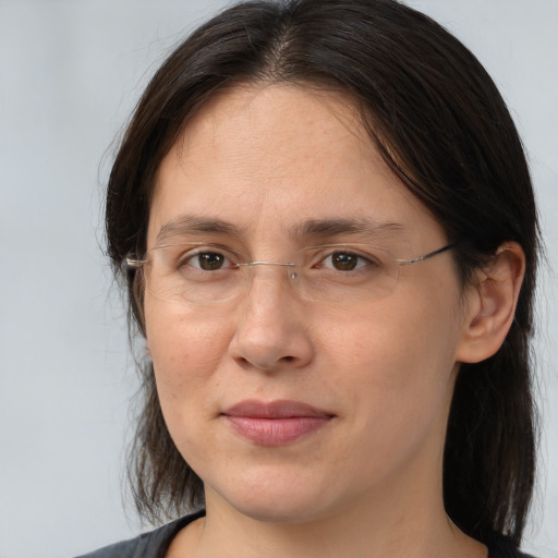 Joyful white adult female with medium  brown hair and brown eyes