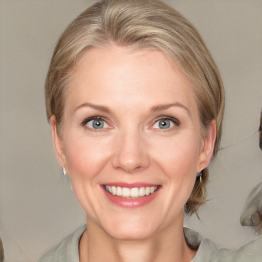 Joyful white adult female with medium  brown hair and grey eyes