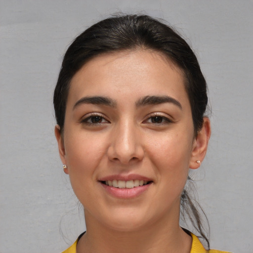 Joyful white young-adult female with short  brown hair and brown eyes