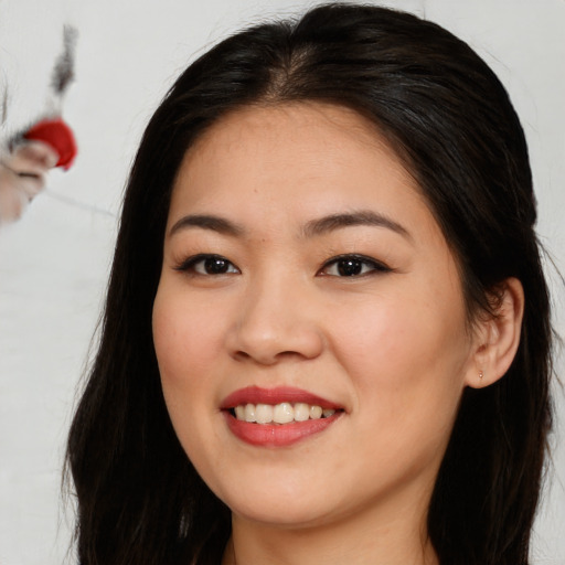 Joyful asian young-adult female with long  brown hair and brown eyes