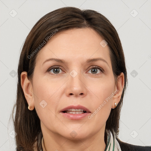 Joyful white adult female with medium  brown hair and grey eyes