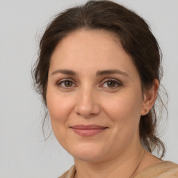 Joyful white adult female with medium  brown hair and brown eyes