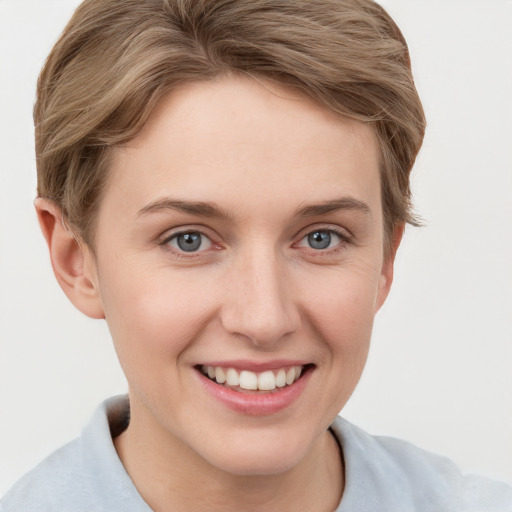 Joyful white young-adult female with short  brown hair and grey eyes