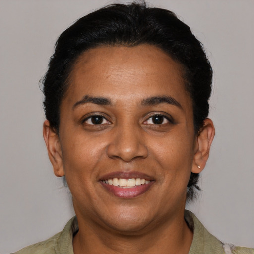 Joyful black young-adult female with short  brown hair and brown eyes