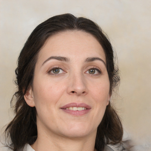 Joyful white adult female with medium  brown hair and brown eyes