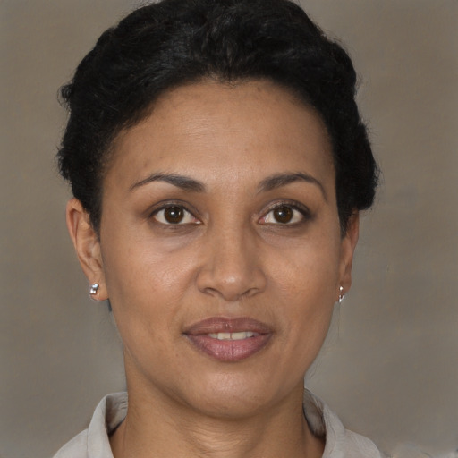 Joyful latino adult female with short  brown hair and brown eyes