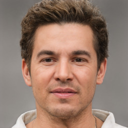 Joyful white adult male with short  brown hair and brown eyes