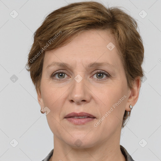 Joyful white adult female with medium  brown hair and grey eyes