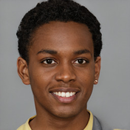 Joyful black young-adult male with short  brown hair and brown eyes