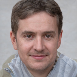 Joyful white adult male with short  brown hair and grey eyes