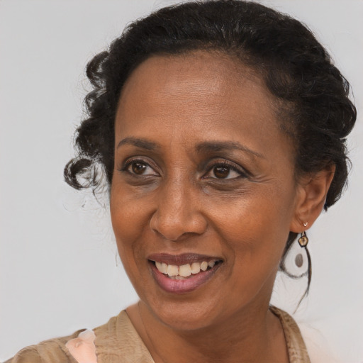 Joyful black adult female with short  brown hair and brown eyes