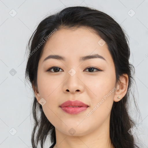 Joyful asian young-adult female with long  black hair and brown eyes