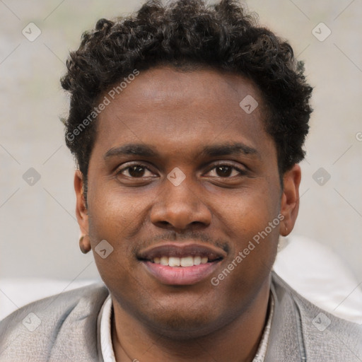 Joyful black young-adult male with short  brown hair and brown eyes