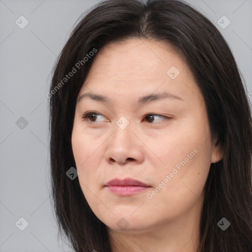 Joyful asian young-adult female with long  brown hair and brown eyes