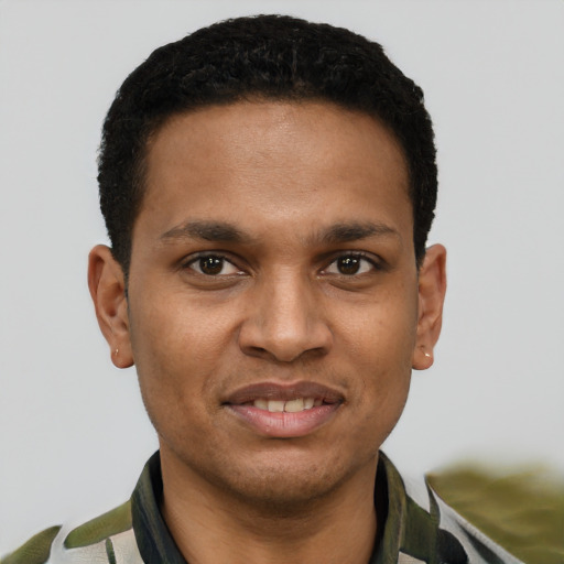 Joyful black young-adult male with short  brown hair and brown eyes