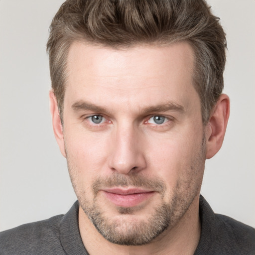 Joyful white adult male with short  brown hair and grey eyes