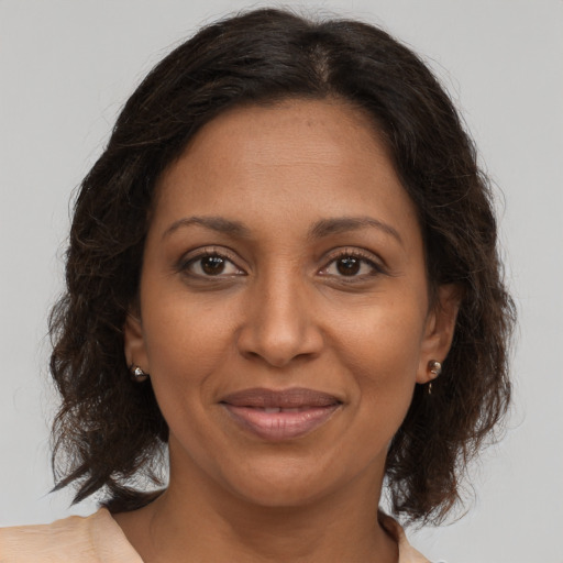 Joyful black adult female with medium  brown hair and brown eyes