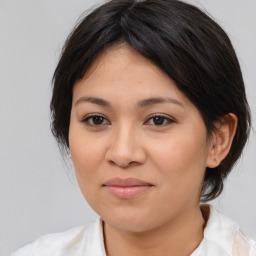 Joyful asian young-adult female with medium  brown hair and brown eyes