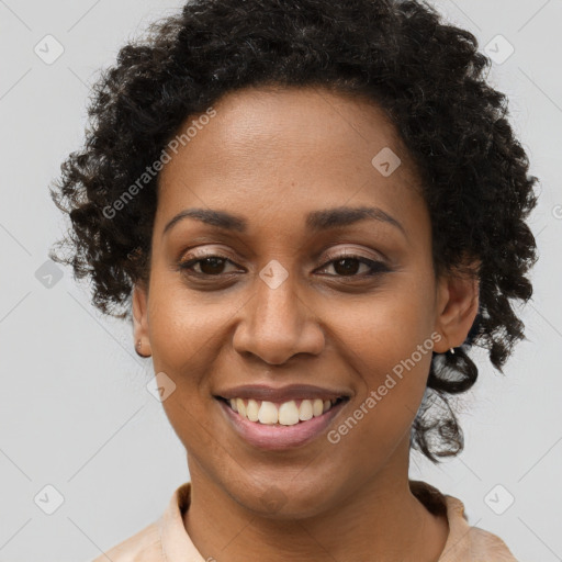 Joyful black young-adult female with long  brown hair and brown eyes