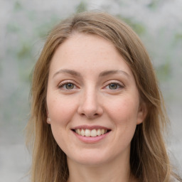 Joyful white young-adult female with long  brown hair and green eyes