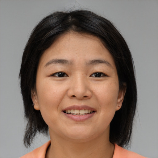 Joyful asian young-adult female with medium  brown hair and brown eyes