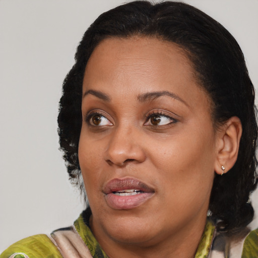 Joyful black adult female with medium  brown hair and brown eyes