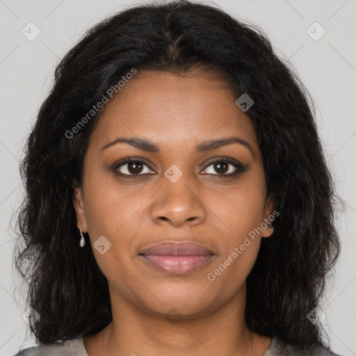 Joyful black young-adult female with long  brown hair and brown eyes