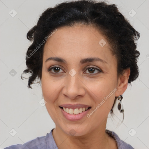 Joyful latino adult female with medium  brown hair and brown eyes