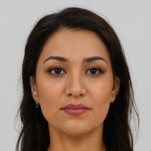 Joyful latino young-adult female with long  brown hair and brown eyes