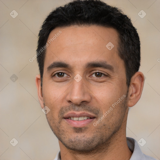 Joyful latino young-adult male with short  black hair and brown eyes