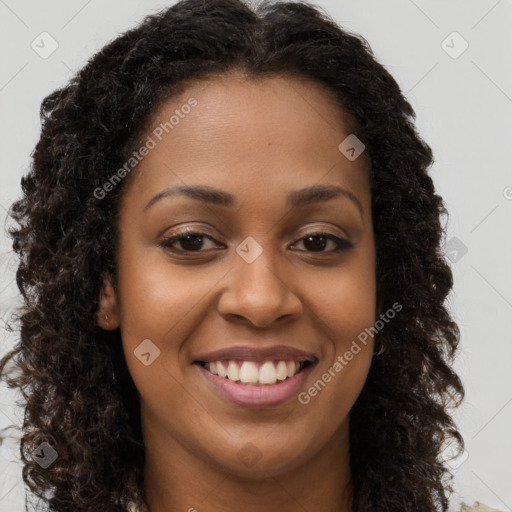 Joyful black young-adult female with long  brown hair and brown eyes