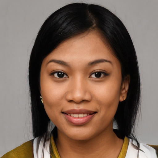 Joyful latino young-adult female with medium  black hair and brown eyes