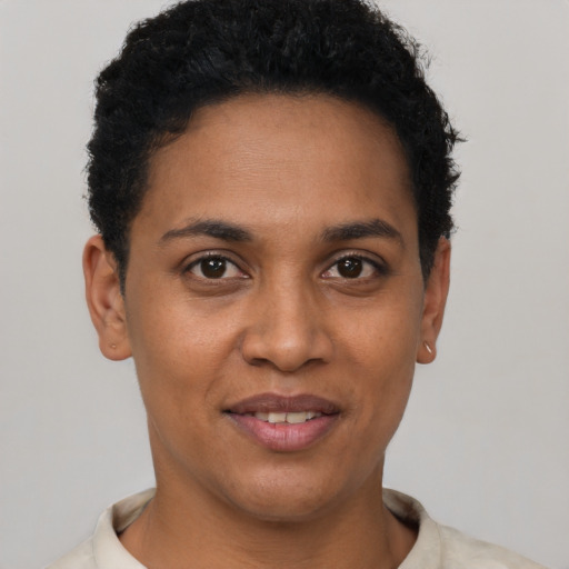 Joyful black young-adult female with short  brown hair and brown eyes