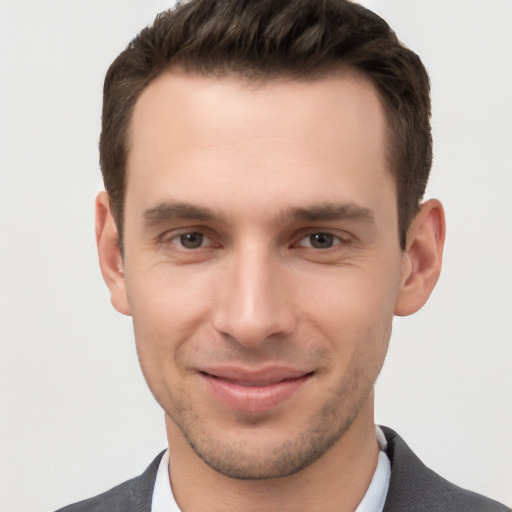 Joyful white young-adult male with short  brown hair and brown eyes